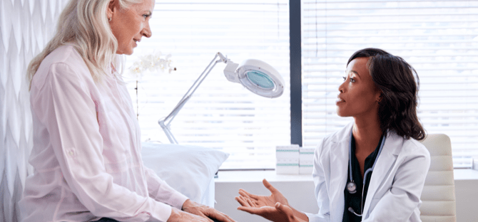 Image of a healthcare professional and a man looking at a tablet