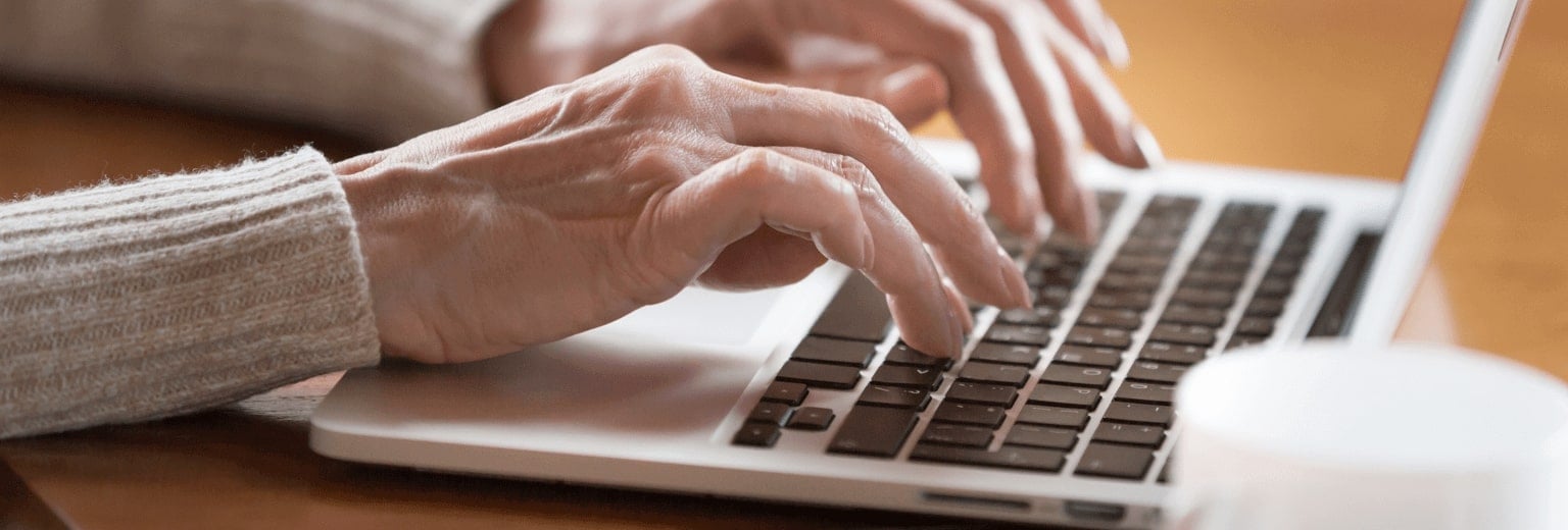 Close up image of female hands typing on laptop