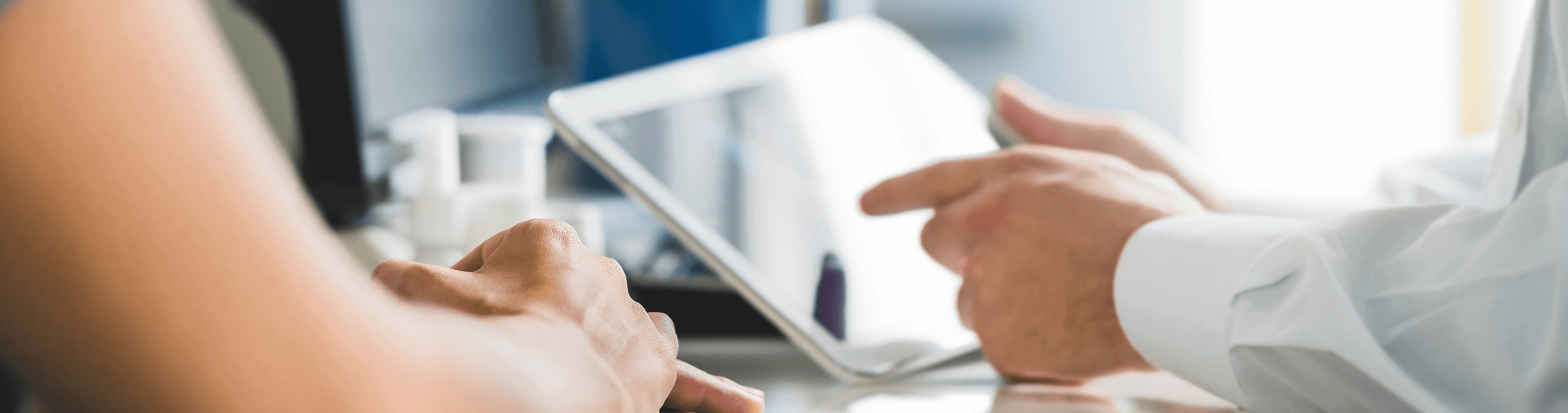 Close-up image of hands holding a tablet