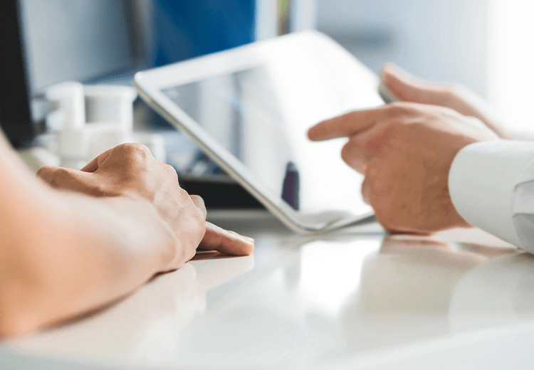 Close-up image of hands holding a tablet