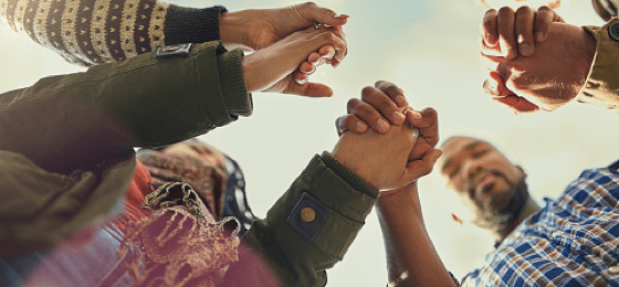 Image of people in a circle holding hands